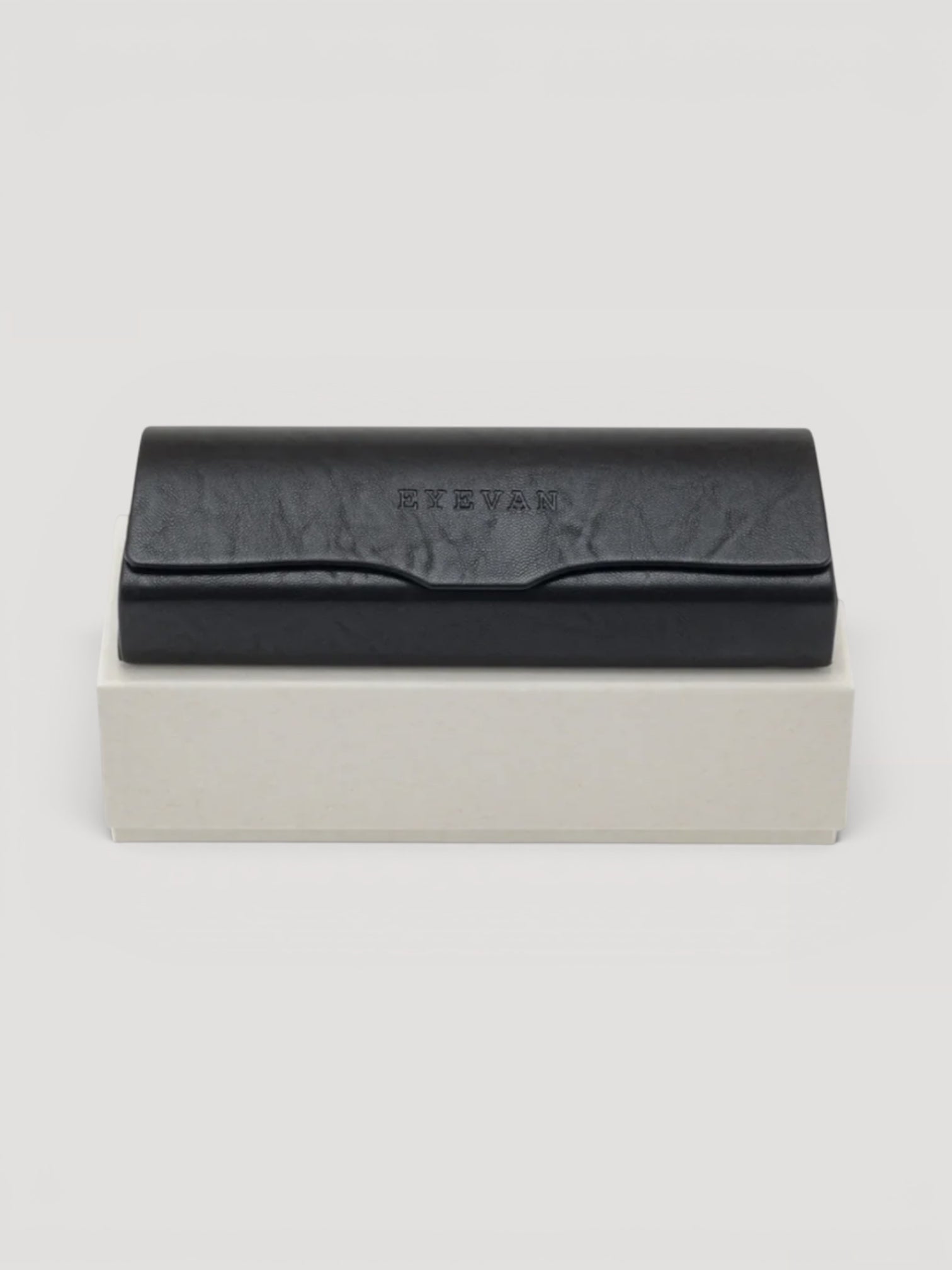 Momentum & Friends EYEVAN black leather protective sunglasses case with embossed logo on a white display box